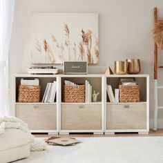 a living room filled with furniture and bookshelves in front of a painting on the wall