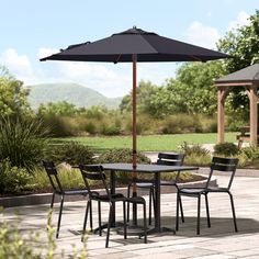 an outdoor table and chairs with an umbrella