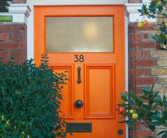 an orange front door with numbers on it