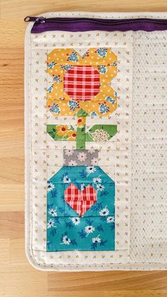 a close up of a piece of fabric on a wooden floor with a flower pot