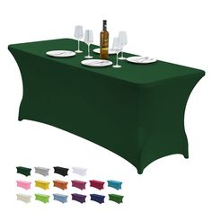 a green table cloth with white plates and wine glasses on it, all in different colors