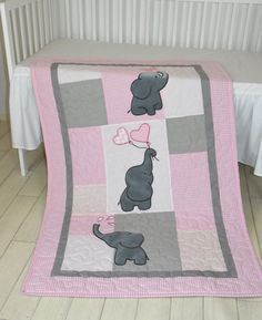 a pink and gray elephant crib bedding set