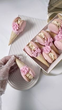 there are some ice cream sandwiches in the box and one is decorated with pink flowers