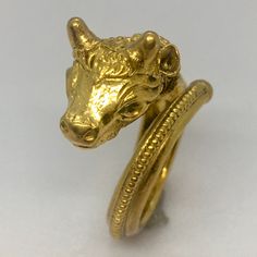 Antique 22K GOLD El Toro Head Ring 7.7 Gram Size 5 Adjustable Granulation Hand Made This antique 22k gold bull head ring is a stunning piece of jewelry that will add a touch of elegance to any outfit. The ring is handcrafted with intricate engravings and is adjustable to fit a size 5 finger. The ring weighs 7.7 grams and is made in the United States. The ring features a beautiful gold color and is designed with a bull head theme, making it a perfect gift for any animal lover. The vintage piece has no stones and is unisex, making it suitable for anyone to wear. This ring is a unique and original piece of jewelry that will make a statement in any collection. 5 Fingers, Bull Head, Head Ring, 7 And 7, 22k Gold, Early 20th Century, Hallmark, Favorite Jewelry, Statement Rings