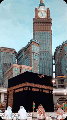 an image of the kabab in front of some buildings with a clock on it