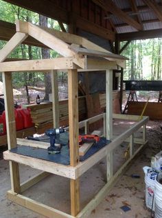 a house built into the side of a building with tools on it and some other items around