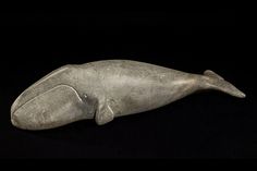 a sculpture of a whale on a black background