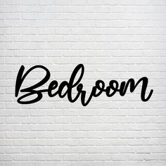 the word bedroom written in black ink on a white brick wall