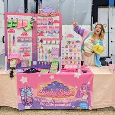 a woman standing next to a table with toys on it