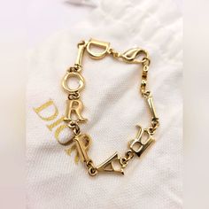 Add A Touch Of Elegance To Your Look With This Stunning Chic Christian Dior "Dior Paris" Spellout Gold Bracelet. Crafted With A Focus On Detail, This Bangle Bracelet Features A Beautiful Gold Color That Complements Any Outfit. The Bracelet Is Designed To Showcase The Iconic Dior Paris Logo, Making It A Must-Have For Any Fashion Jewelry Collection. This Bracelet Is Perfect For Any Occasion And Is Ideal For Those Who Want To Add A Touch Of Sophistication To Their Everyday Look. It Is Made From Hig Dior Gold, Paris Jewelry, Dior Paris, Paris Logo, Logo Making, Dior Jewelry, Diamond Bangle, Womens Jewelry Bracelets, Bangle Bracelet