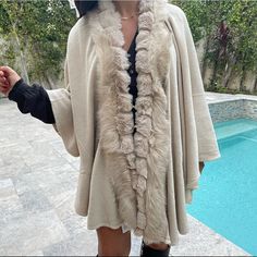 Throw On Shawl/Poncho Super Chic Faux Fur Detailing One Size Fall Poncho With Faux Fur Trim Cape, Fall Faux Fur Cape, Chic One Size Poncho For Winter, Chic One Size Cape Poncho, Chic One-size Cape Poncho, Chic Winter Shawl Poncho, Chic Winter Shawl Cape, Chic Shawl Outerwear One Size, Chic Shawl Style Outerwear One Size