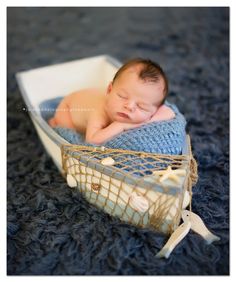 a baby is sleeping in a basket on the floor