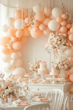 a white table topped with lots of cake and balloons