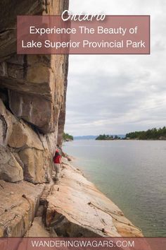 a man climbing up the side of a cliff next to a lake with text overlay reading experience the beauty of lake superior provincial park