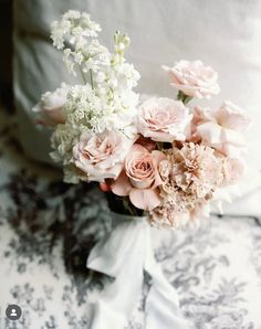 a bouquet of flowers sitting on top of a bed