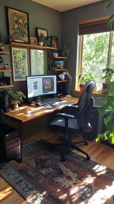 a home office with two computers on the desk and plants in the window sill