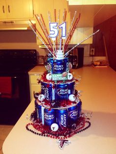 a birthday cake made out of cans and baseballs