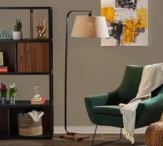 a living room with a chair, lamp and bookshelf on the wall in front of it