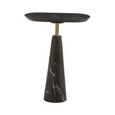 a black marble side table with gold metal legs and an oval shaped top, on a white background