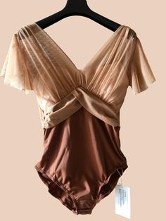 a brown swimsuit hanging on a hanger