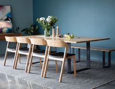 a wooden table with four chairs around it