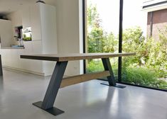 a modern kitchen with an island bench in the center and large glass doors leading outside