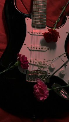 an electric guitar with flowers on it