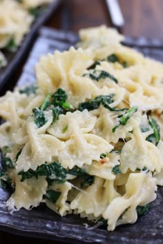 pasta with spinach and cheese is on a baking sheet, ready to be eaten