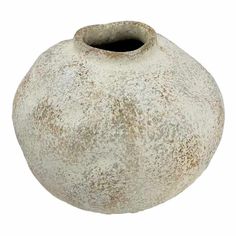 a white vase with brown speckles on the outside and inside, sitting in front of a white background