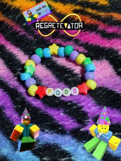 a colorful bracelet with legos on it and the words regrettata spelled in white