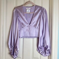 Beautiful Color And Texture Blouse! Never Worn And In Perfect Condition Super Cute For A Special Night! Purple Satin Top For Spring, Spring Purple Satin Top, Fitted Feminine Lavender Blouse, Spring Cropped Satin Blouse, Lavender Top For Night Out In Spring, Fitted Lavender V-neck Blouse, Feminine Lavender V-neck Blouse, Elegant Lavender Top For Parties, Elegant Lavender Tops For Party