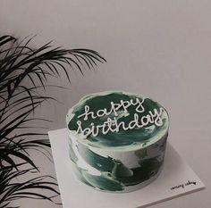 a black and white photo of a birthday cake with the words happy birthday written on it