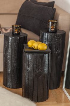 two black wooden stools with lemons on them