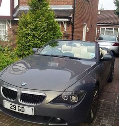 a bmw z4 convertible parked in front of a house