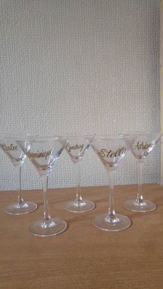 five wine glasses sitting next to each other on a table