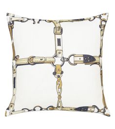 a white pillow with chains and buckles on it