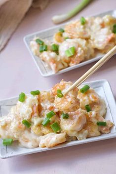 two white plates filled with shrimp and rice on top of a pink table cloth next to chopsticks