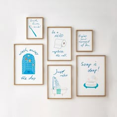 four framed pictures on the wall with blue and white artwork above them, each depicting different bathroom items