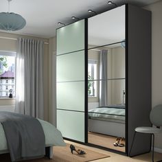 a bedroom scene with focus on the bed and mirrored closet doors