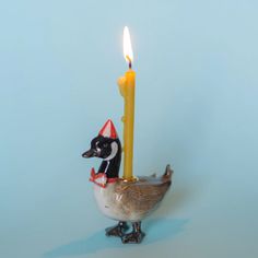 a duck with a candle in its beak