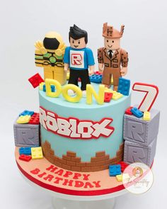 a birthday cake with lego figures on top