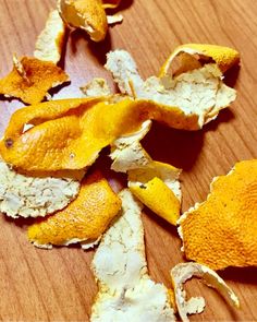 peeled orange peels sitting on top of a wooden table