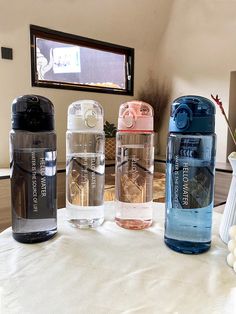 three water bottles sitting on top of a table