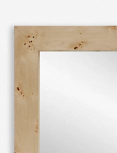 a mirror that is made out of wood and has holes in the bottom half of it