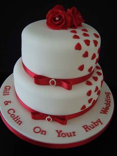 a three tiered cake with red ribbon and rose on top that says, i'm going on your ruby wedding day