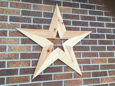 a wooden star on the side of a brick wall