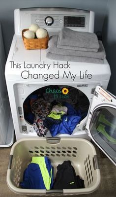 the laundry basket is filled with clothes next to an appliance and dryer