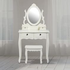 a white dressing table with a mirror and stool