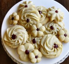 a white plate topped with cookies covered in frosting