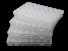 three plastic storage containers stacked on top of each other in front of a black background